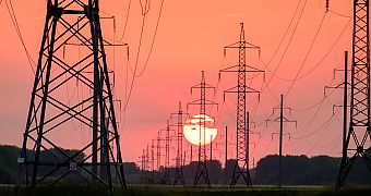 Electricity pylons in front of sunset